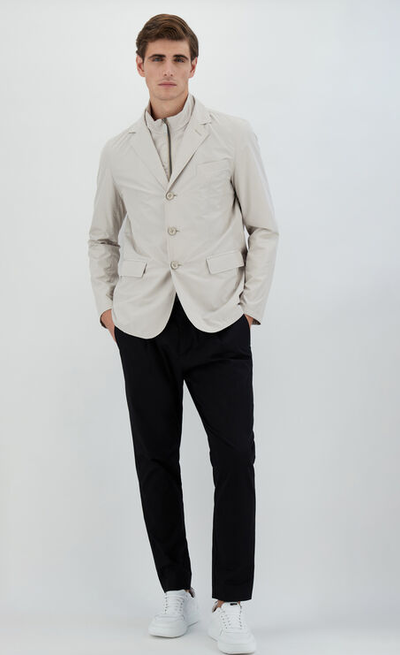 A man wearing a Herno chantilly color blazer