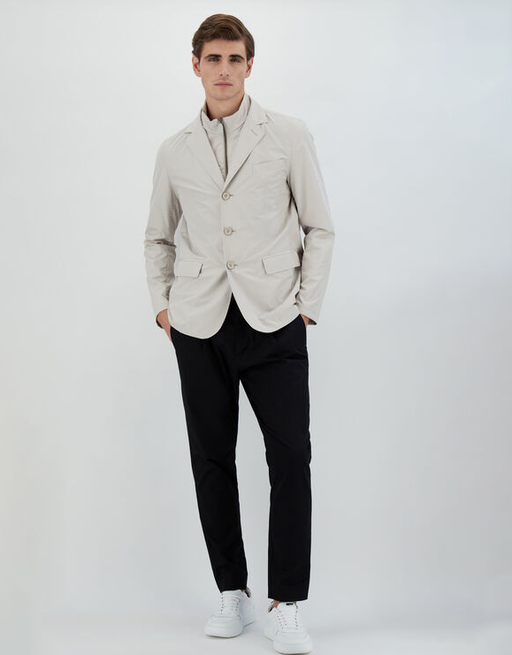 A man wearing a Herno chantilly color blazer
