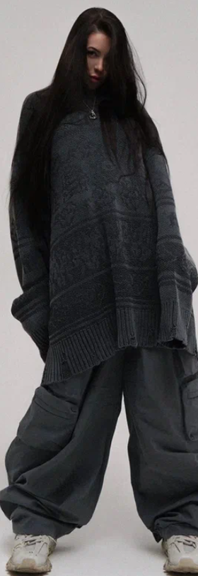 A woman wearing a NIKIFILINI grey sweater
