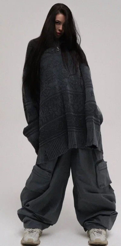 A woman wearing a NIKIFILINI grey sweater