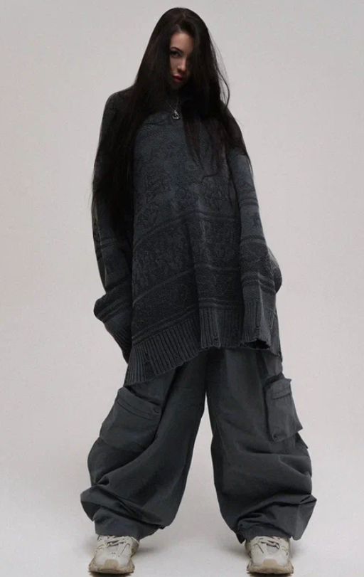 A woman wearing a NIKIFILINI grey sweater