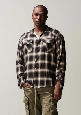 A man wearing a Greg Lauren black/white shirt