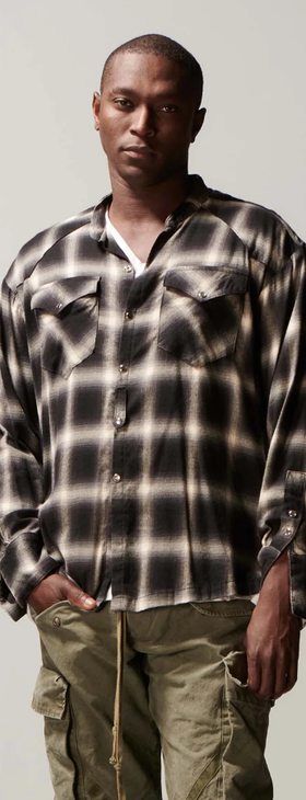 A man wearing a Greg Lauren black/white shirt