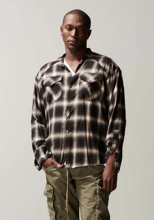 A man wearing a Greg Lauren black/white shirt
