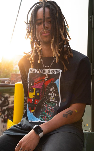 A man wearing a CXXII Apparel black t-shirt
