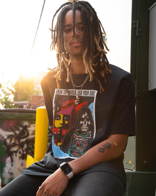 A man wearing a CXXII Apparel black t-shirt