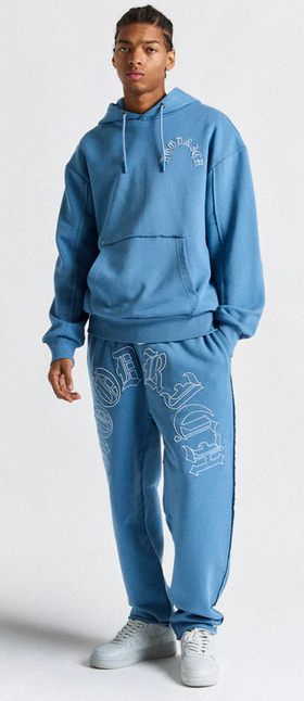 A man wearing a Hoodrich blue Hoodie and Joggers
