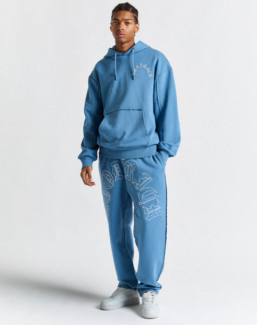 A man wearing a Hoodrich blue Hoodie and Joggers