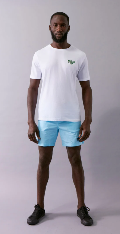 A man wearing a Wata optimism white t-shirt