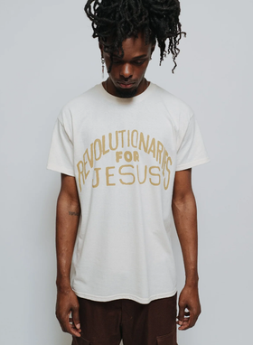 A man wearing a NHIM Apparel white t-shirt