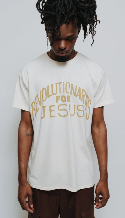 A man wearing a NHIM Apparel white t-shirt