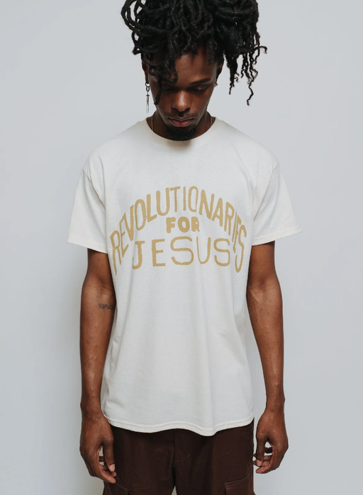 A man wearing a NHIM Apparel white t-shirt