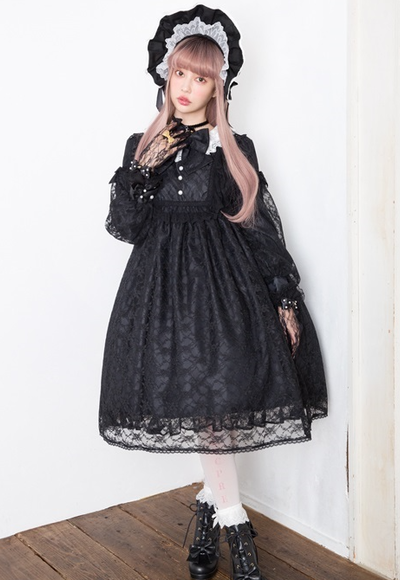 A woman wearing a Angelic Pretty classic bisque doll black one piece