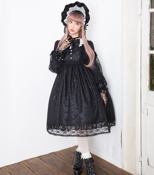 A woman wearing a Angelic Pretty classic bisque doll black one piece