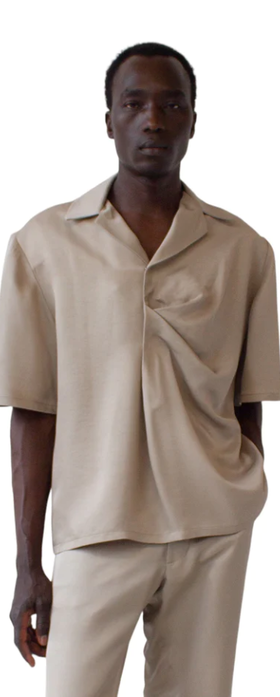 A man wearing a Bianca Saunders soft beige bailey shirt