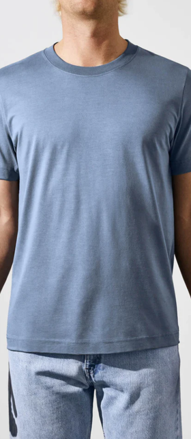 A man wearing a CDLP steel blue t-shirt