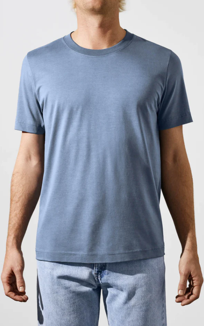 A man wearing a CDLP steel blue t-shirt