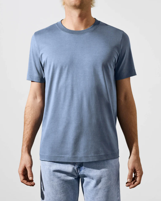 A man wearing a CDLP steel blue t-shirt
