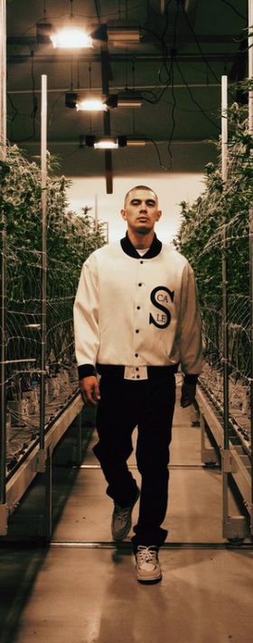 A man wearing a Black Scale white jacket
