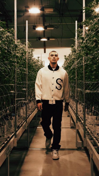 A man wearing a Black Scale white jacket