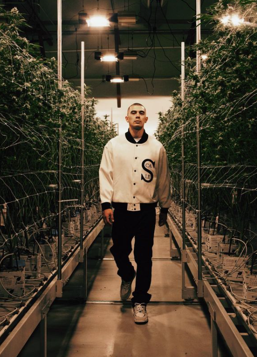 A man wearing a Black Scale white jacket