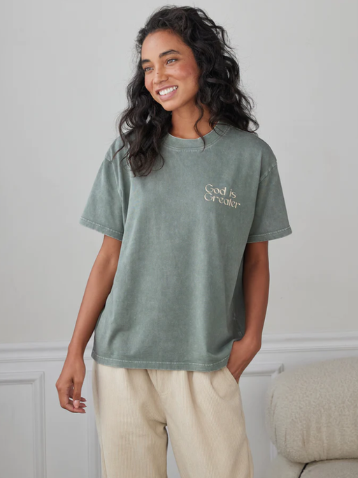 A woman wearing a Elevated Faith moss t-shirt