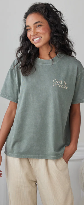 A woman wearing a Elevated Faith moss t-shirt