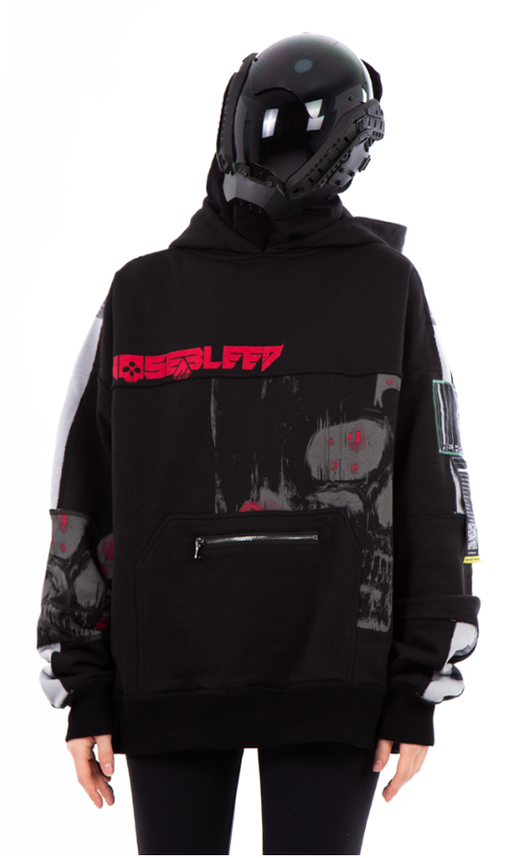 A person wearing a Heartz Anime Clothing pathchwork oversized special black hoodie