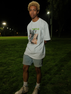 A man wearing a Paradise Youth Club white t-shirt