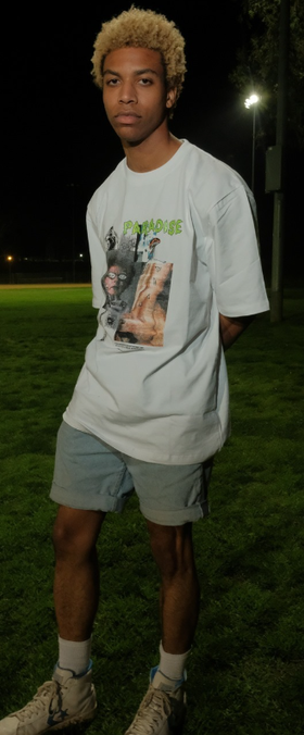 A man wearing a Paradise Youth Club white t-shirt
