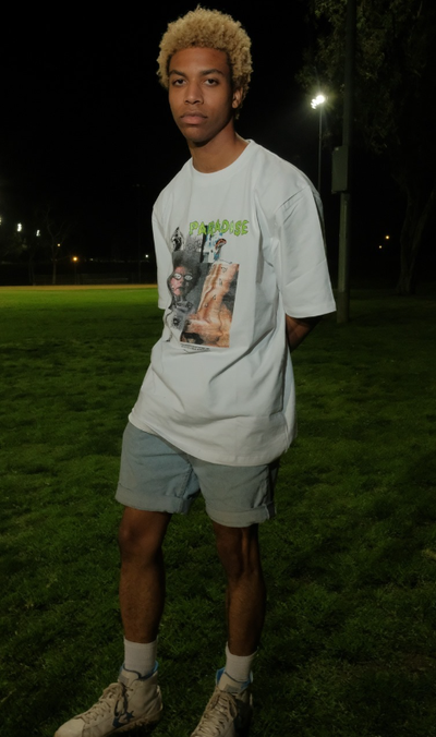 A man wearing a Paradise Youth Club white t-shirt