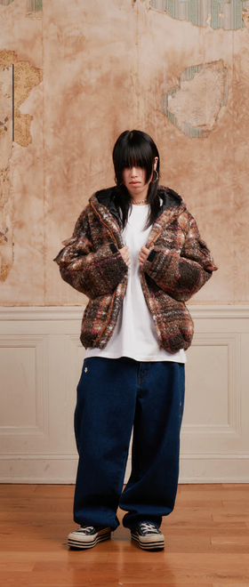 A woman wearing a Ronin Division coffee color swirl fleece jacket