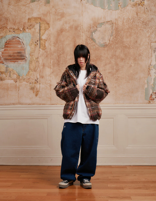 A woman wearing a Ronin Division coffee color swirl fleece jacket