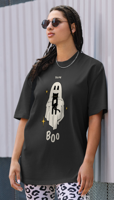 A woman wearing a Yujin Clothing boo! cat oversized faded black t-shirt