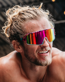 A man wearing a colorful pair of Blenders sunglasses