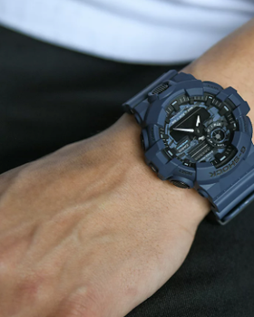 A man wearing a G-SHOCK watch in dark grey