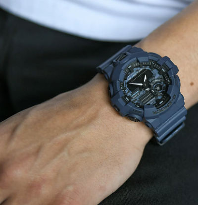 A man wearing a G-SHOCK watch in dark grey
