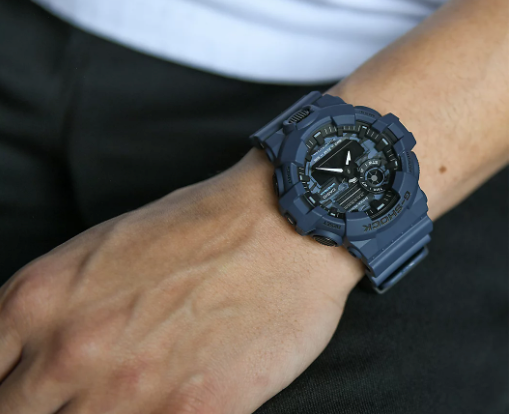 A man wearing a G-SHOCK watch in dark grey