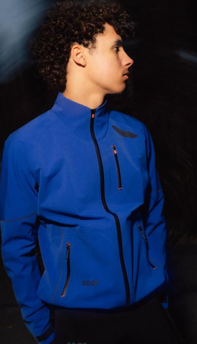 A man wearing all weather blue jacket