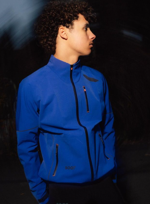 A man wearing all weather blue jacket