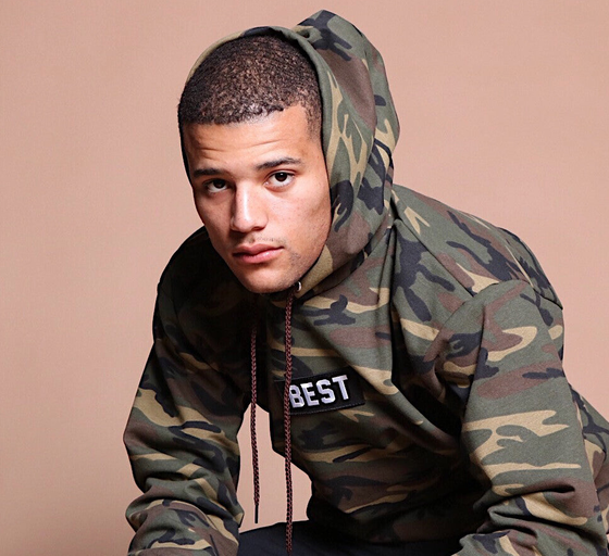 A man wearing army printed hoodie