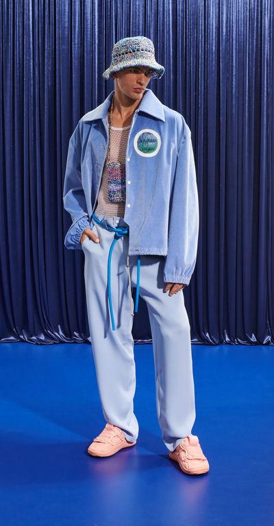 A man wearing a light blue Pigalle 2023 outfit