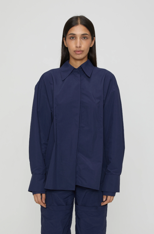 A woman wearing navy blue marie shirt