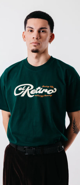 A man wearing green "El retiro" tee
