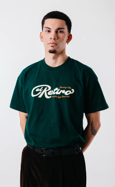 A man wearing green "El retiro" tee