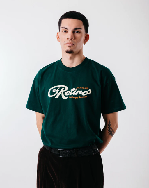 A man wearing green "El retiro" tee