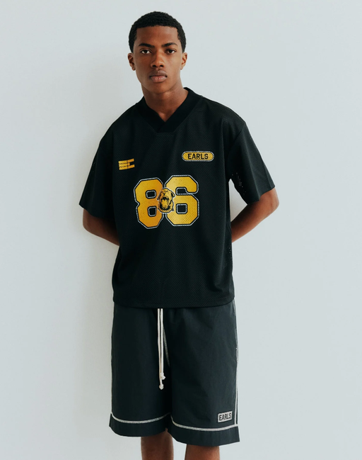 A man wearing black championship mesh jersey
