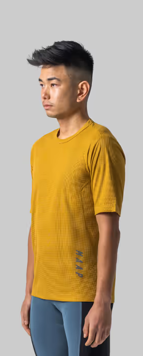 A man wearing honey color t-shirt