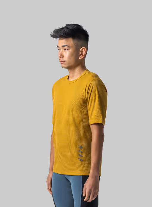 A man wearing honey color t-shirt