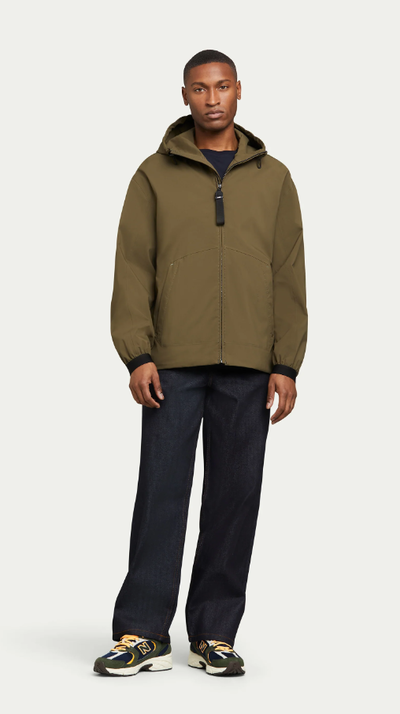 A man wearing olive pace hoodie
